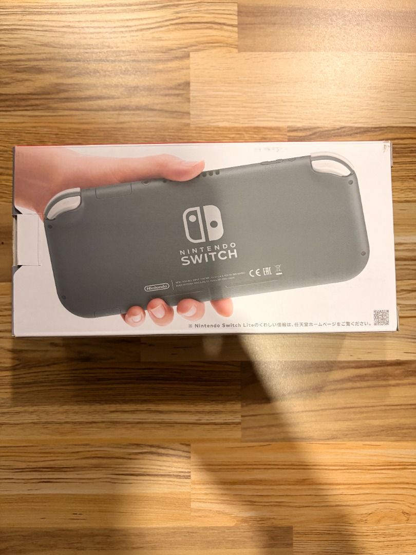 Nintendo Switch Lite Grey Handheld Console 2025 (Category: Nintendo) located in Manila. Submitted by jeffalegre02 (Listing ID 1471119579, Image 3). Description: - Model: Nintendo Switch Lite (Grey, Standard Handheld Version) - Condition: Excellent, stored in a clear protective wrapper inside the original retail box - Features: Standard button layout, clear screen with default background, and Japanese text details on packaging - Inclusions: Consol