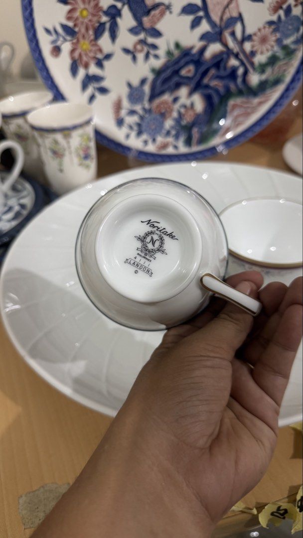 Noritake Klandon Fine Bone China Teacups (Category: Coffee & Tea Tableware) located in Masinloc. Submitted by kristineba02273 (Listing ID 1471157839, Image 3). Description: - Brand/Pattern: Noritake Klandon - Material: Fine bone china / white porcelain - Origin: Made in the Philippines - Quantity: Set of 2 teacups (one with a teal border, one with a burgundy band) - Design: Delicate pastel floral clusters and elegant gold trim on rims and footed 