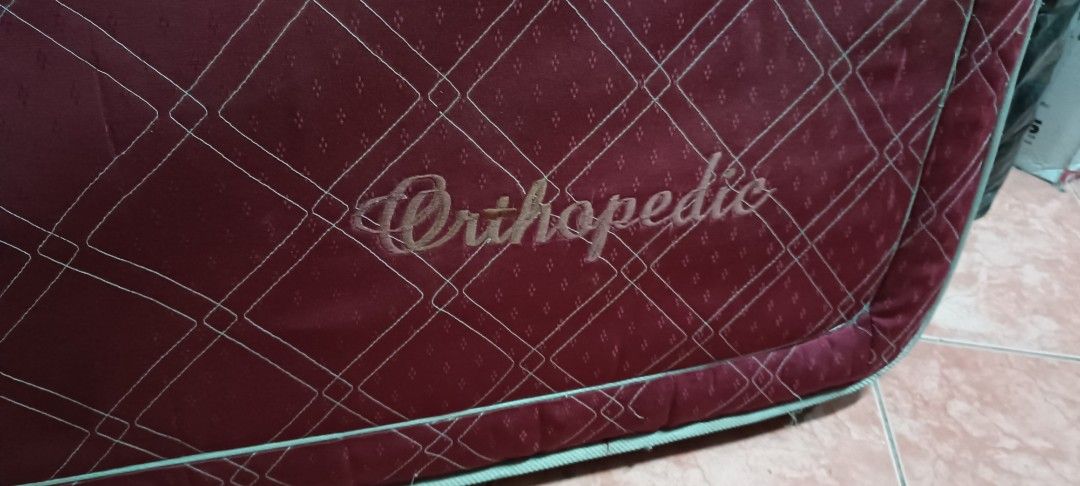 Orthopedic Red Mattress (Category: Bed Frames & Mattresses) located in Manila. Submitted by michaelde.guzman (Listing ID 1471226365, Image 1). Description: - Type: Red orthopedic mattress - Design: Quilted diamond pattern with white piping trim - Condition: Sturdy build with some loose threads and general fabric wear - Ideal For: Guest rooms or spare beds - Note: Buyer must arrange own transport for collection.