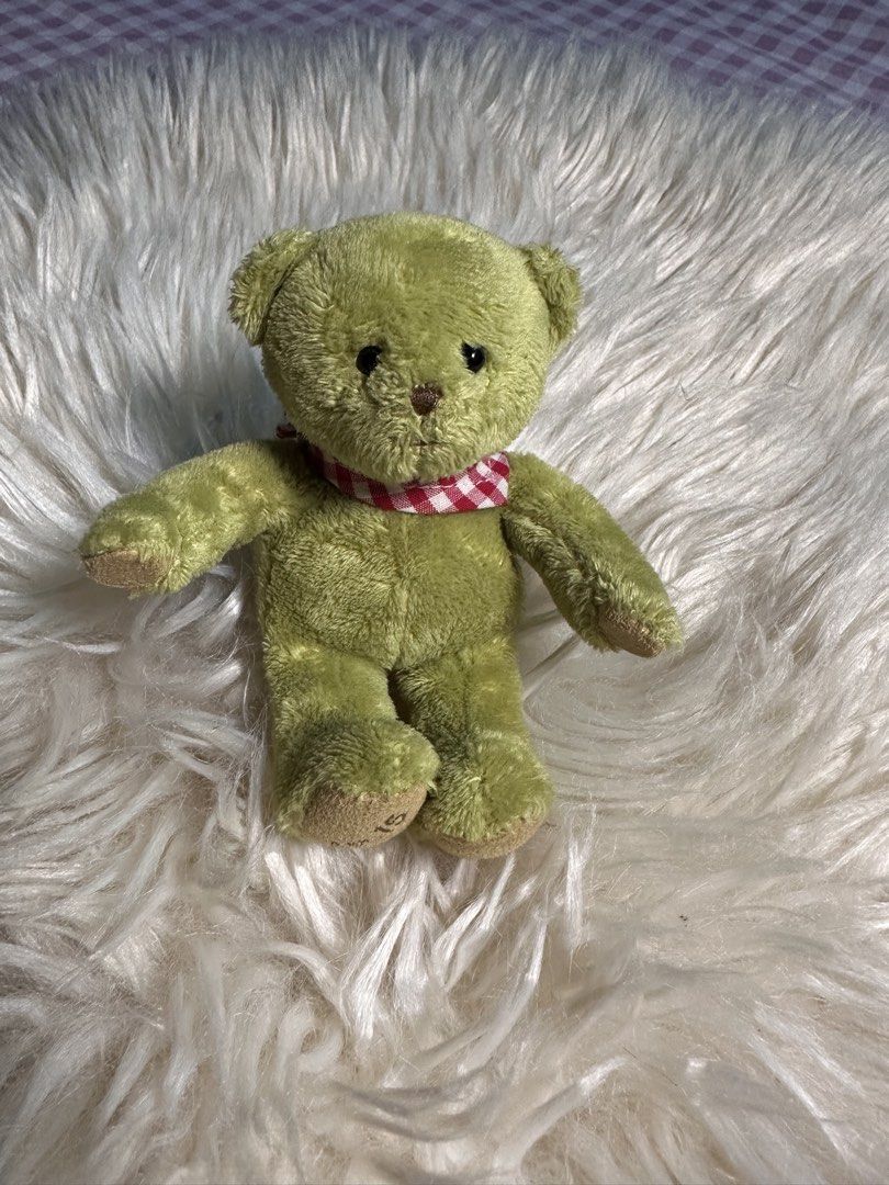 Petit Coup cute green plush teddy bear keychai (Category: Plushies & Soft Toys) located in Davao. Submitted by favoritepreloved (Listing ID 1471268407, Image 1). Description: 💜 wearing a red-and-white gingham checkered scarf and attached to a colorful braided strap..