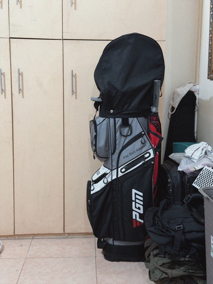 PGM Pro Golf Master Golf Bag with Clubs (Category: Golf) located in Manila. Submitted by theclassicme (Listing ID 1471155357, Image 2). Description: - Brand/Model: PGM Pro Golf Master Cart Bag - Colorway: Stylish Black, Grey, and White - Organization: Integrated divider top keeps your clubs neatly separated - Storage: Multiple zippered pockets for all your gear, balls, and tees - Convenience: Sturdy top handle and built-in umbrella slot - Protect
