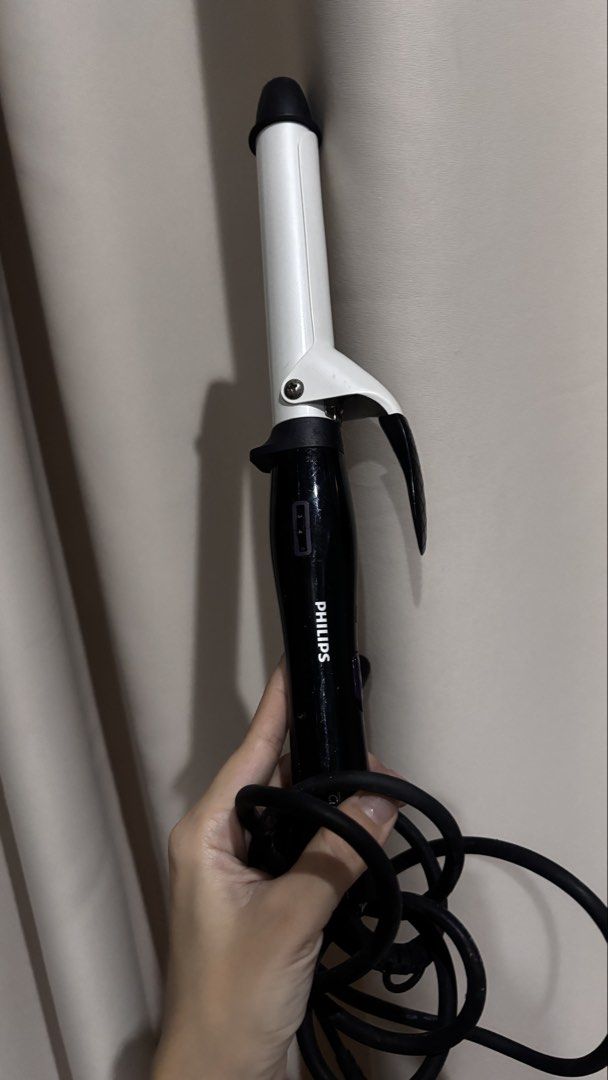 Philips CurlControl Curling Iron HP8605 (Category: Hair) located in Makati City. Submitted by kaysgarage (Listing ID 1471219171, Image 1). Description: - Brand/Model: Philips CurlControl HP8605 - Design: Black and white handle with adjustable temperature settings - Barrel: Standard barrel with secure clamp - Voltage: Universal 110-240V (great for travel) - Condition: Powers on and heats up properly; minor scuffs on the black plastic from storage 