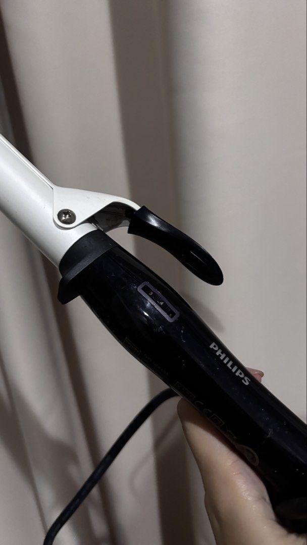 Philips CurlControl Curling Iron HP8605 (Category: Hair) located in Makati City. Submitted by kaysgarage (Listing ID 1471219171, Image 2). Description: - Brand/Model: Philips CurlControl HP8605 - Design: Black and white handle with adjustable temperature settings - Barrel: Standard barrel with secure clamp - Voltage: Universal 110-240V (great for travel) - Condition: Powers on and heats up properly; minor scuffs on the black plastic from storage 