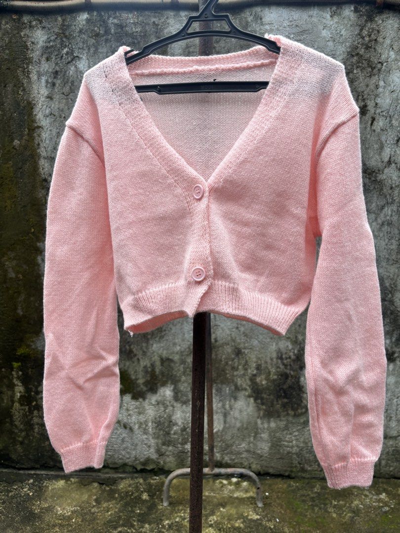 Pink Crop Knit Cardigan (Category: Coats, Jackets and Outerwear) located in Manila. Submitted by kszortpdrss (Listing ID 1471156768, Image 1). Description: - Color: Light Pink - Style: Cropped cardigan with V-neck and front button closure - Details: Long sleeves with ribbed cuffs and hem - Material: Soft, cozy knit texture - Versatility: Perfect layering piece for air-conditioned rooms or cooler weather - Condition: Excellent / Like new.