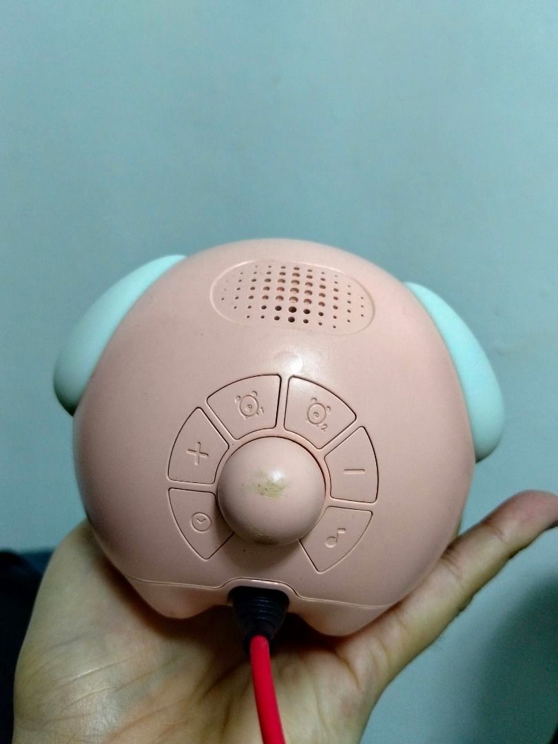 Pink LED digital alarm clock with glowing night light (Category: Clocks) located in Quezon City. Submitted by haaiv (Listing ID 1471143576, Image 2). Description: - Pink digital alarm clock with cute glowing ear-shaped side lights - Clear LED display with bright white illumination - Easy-to-use buttons on the back for alarm, music, and volume settings - Conveniently powered via USB cable (attached at the bottom) - Condition: Fully functional with
