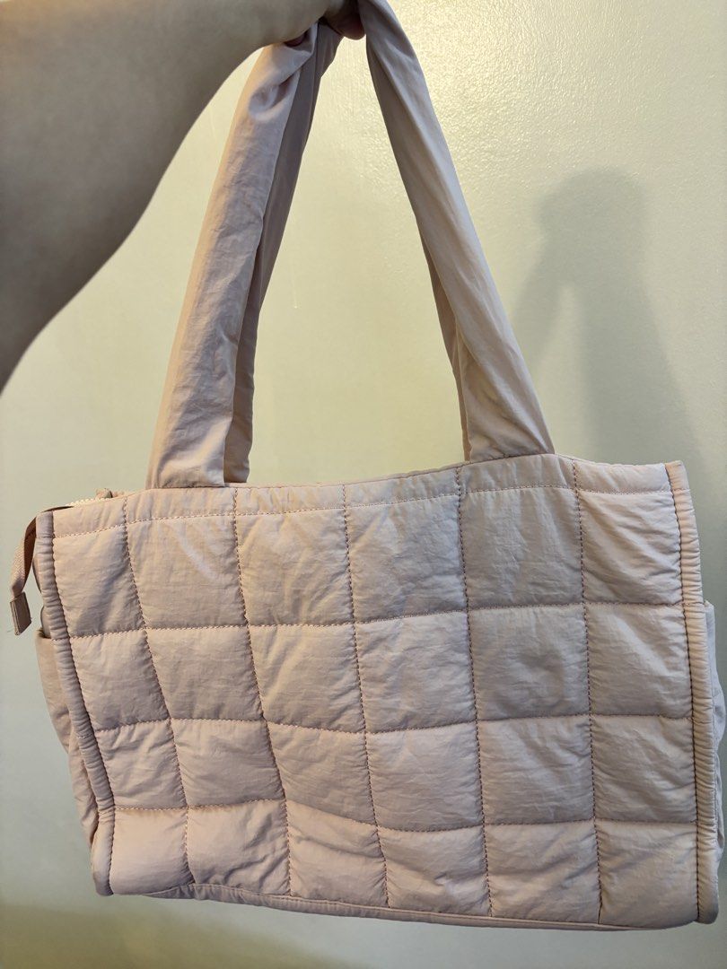 Pink Quilted Tote Bag with Shoulder Straps (Category: Tote Bags) located in Pasig City. Submitted by pammyyyy.11 (Listing ID 1471234331, Image 2). Description: - Color: Soft pink - Material: Lightweight and durable nylon - Closure: Secure main zipper - Carrying Options: Sturdy top handles and adjustable shoulder strap - Storage: Roomy main compartment, multiple slip pockets, and a mesh zippered pocket - Condition: Brand new.