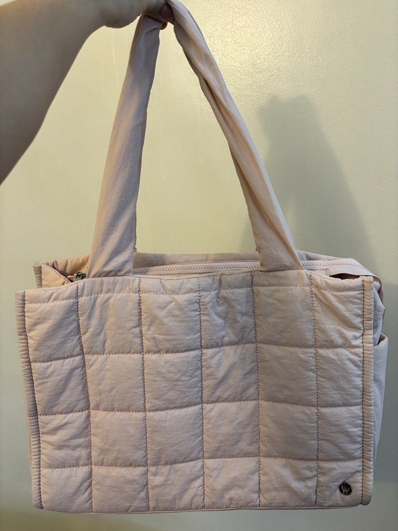 Pink Quilted Tote Bag with Shoulder Straps (Category: Tote Bags) located in Pasig City. Submitted by pammyyyy.11 (Listing ID 1471234331, Image 1). Description: - Color: Soft pink - Material: Lightweight and durable nylon - Closure: Secure main zipper - Carrying Options: Sturdy top handles and adjustable shoulder strap - Storage: Roomy main compartment, multiple slip pockets, and a mesh zippered pocket - Condition: Brand new.