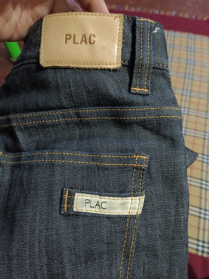 PLAC Dark Wash Denim Jeans Size 31 (Category: Jeans) located in General Santos City (Dadiangas). Submitted by freehorse.5f2a61 (Listing ID 1471226736, Image 3). Description: - Brand: PLAC - Style: Dark wash straight leg denim jeans - Size: 31 (indicated on inner tag) - Material: Comfortable cotton, polyester, and polyurethane blend - Details: Orange contrast stitching, back waistband leather patch, and branded rear pocket tag - Condition: Excelle