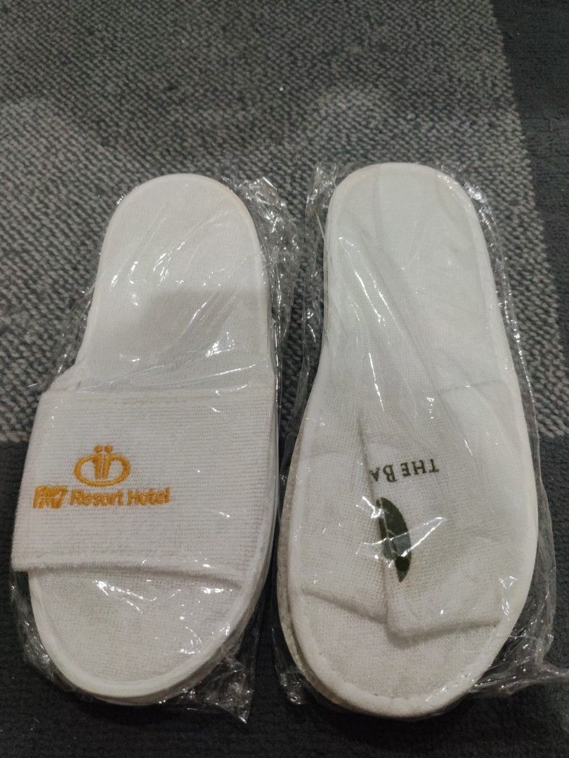 PM7 Resort Hotel White Open Toe Slippers (Category: Slippers and slides) located in Manila. Submitted by aaronpaula05546 (Listing ID 1471188661, Image 1). Description: - Brand: PM7 Resort Hotel - Color: White with yellow embroidery and green leaf graphic - Material: Comfortable terry cloth strap and clean white sole - Condition: Brand new, never opened, still sealed in original clear plastic - Perfect for: Guests, travel, lounging, or hotel colle