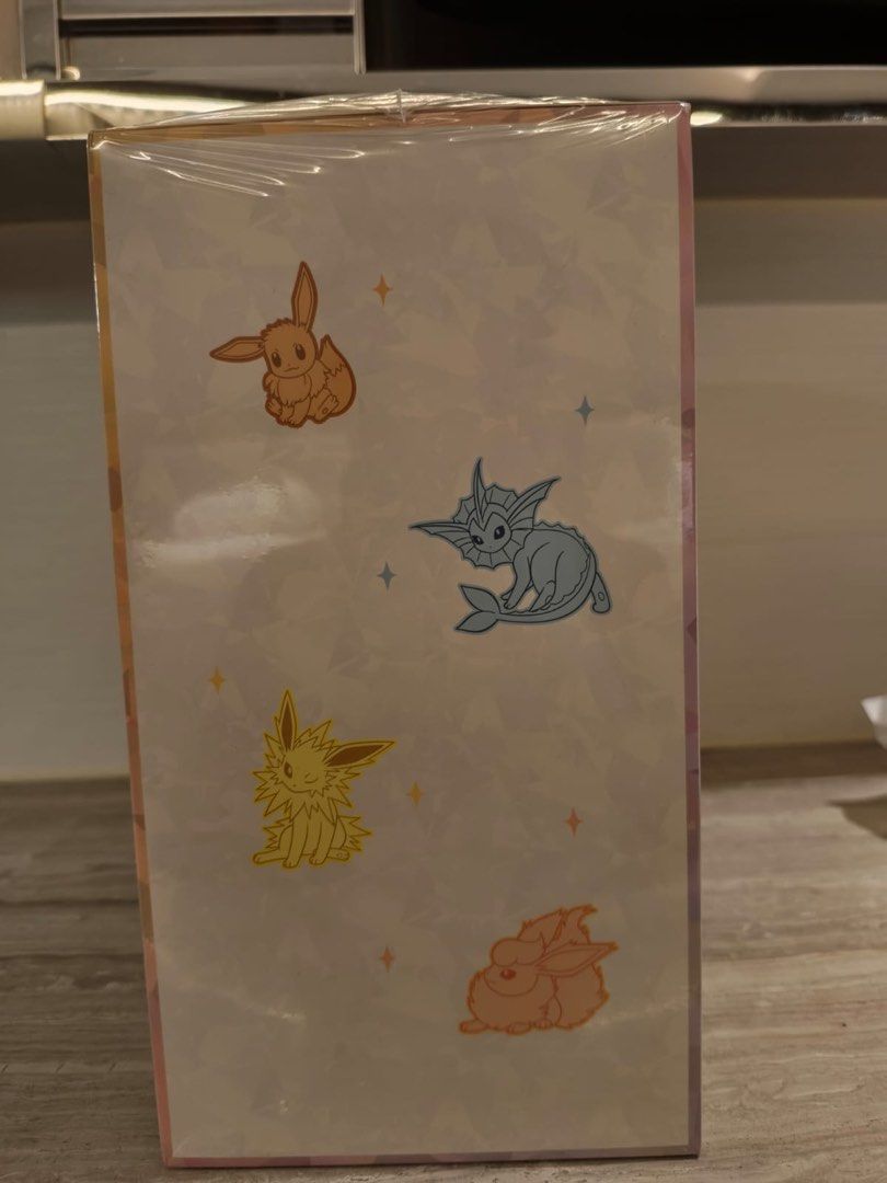 Pokemon Eevee and Friends (Category: Card Boxes & Cases) located in Manila. Submitted by shiro_shimada (Listing ID 1471262885, Image 3). Description: selling my sealed eevee and friends gift box • 15 Booster Packs: Terastal Grand Gathering (CSV9.5C) booster packs (each containing 10 cards). • 2 Exclusive Foil Promo Cards: Full-art Espeon ex (297/SV-P) and Umbreon ex (298/SV-P). • Playmat: An Eevee & Friends-themed playmat with its own storage cas