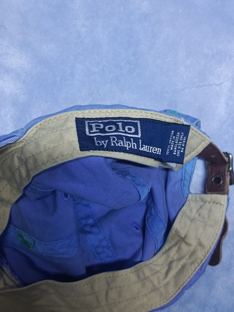 Polo Ralph Lauren Blue Baseball Cap (Category: Caps & Hats) located in City of Isabela. Submitted by warmbird.d06e6f (Listing ID 1471188419, Image 2). Description: - Brand: Polo Ralph Lauren - Color: Classic Blue - Material: 100% Breathable Cotton - Design: Classic six-panel cap with embroidered green pony logo on front - Features: Curved brim, stitched ventilation eyelets - Fit: Fully adjustable strap at the back for a custom fit - Condition: Br