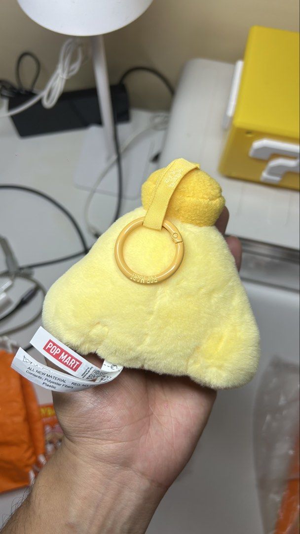 POP MART CRYBABY TEARS LAUNCH PROJECT (Category: Plushies & Soft Toys) located in Quezon City. Submitted by ptrickgo (Listing ID 1471138566, Image 2). Description: - Authentic Pop Mart Crybaby yellow plush keychain - Triangle-shaped stuffed toy with cute embroidered face and round cheeks - Fluffy, soft texture in a bright yellow color - Equipped with a yellow plastic ring loop and branding text on the back - Original product tag attached at the b