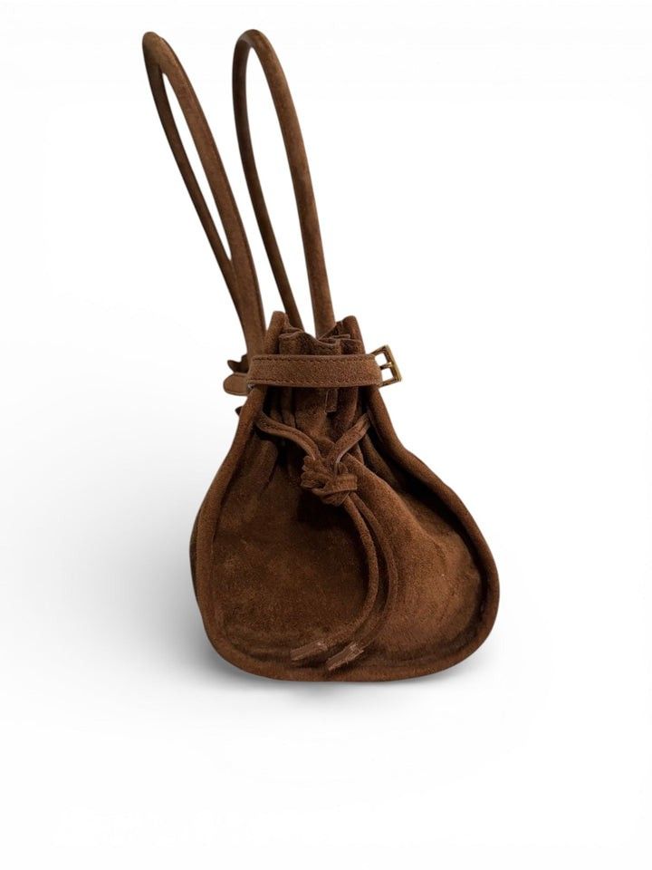 Prada Brown Suede Shoulder Bag (Category: Luxury Bags & Wallets) located in Pagadian. Submitted by therencethewarriormom (Listing ID 1471153928, Image 3). Description: Prada brown suede shoulder bag with dual top handles. Structured shape featuring gold-tone hardware, buckle belt accents along the perimeter, and the iconic triangular logo plaque on the front. Side profile shows a drawstring closure mechanism. Clean suede finish throughout with re