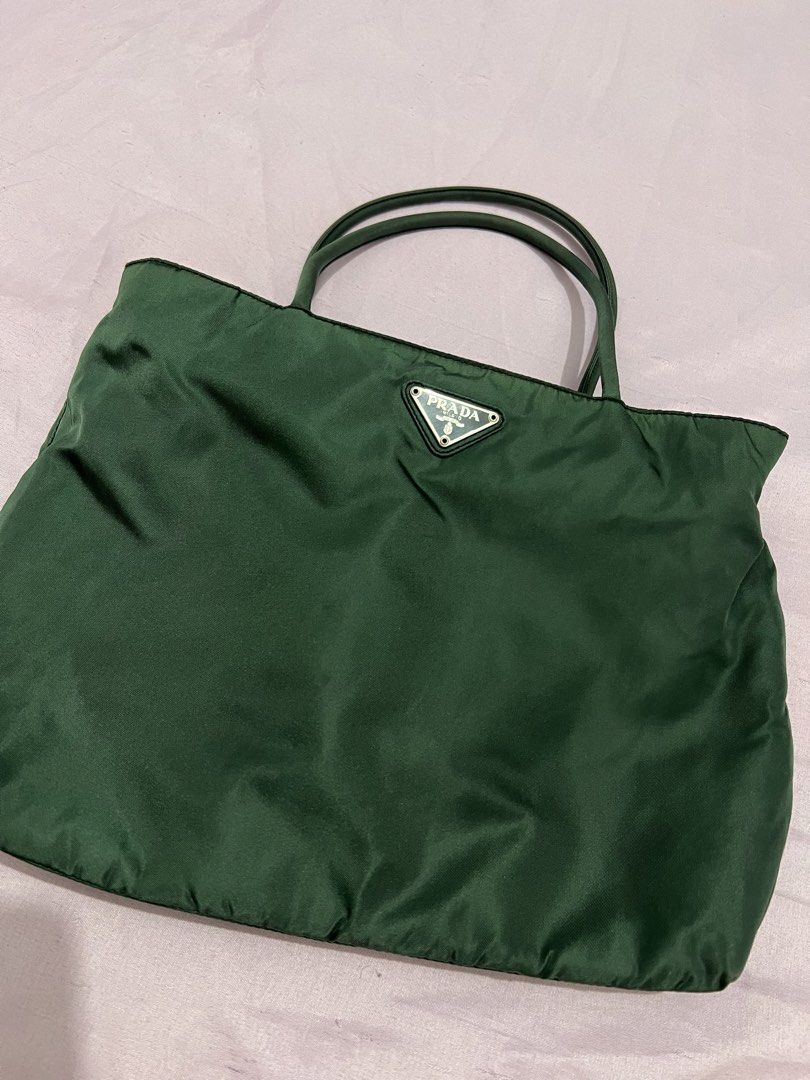 Prada Green Nylon Tote Bag (Category: Luxury Bags & Wallets) located in Manila. Submitted by czaaay (Listing ID 1471125530, Image 1). Description: - Authentic Green Prada tote bag - Made from durable, lightweight nylon material - Features comfortable double shoulder handles - Classic silver-tone Prada triangle logo plaque on the front - Spacious interior to easily hold your daily essentials - Simple, chic, and versatile everyday piece.
