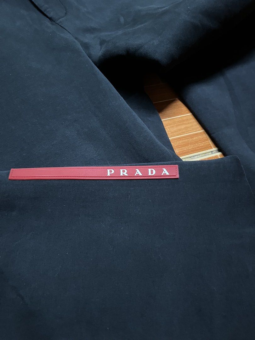 Prada Navy Blue Joggers Sweatpants Size XL (Category: Joggers) located in Manila. Submitted by jlfamiliar69452 (Listing ID 1471143818, Image 2). Description: - Brand: Prada - Item: Navy Blue Joggers - Size: XL (CN 190/104 A) - Origin: Made in Italy - Features: Side stripe details, secure zipped pockets, and signature red Prada logo tab on the lower leg - Details: Includes official Prada inner tag with name section - Condition: 100% authentic and 