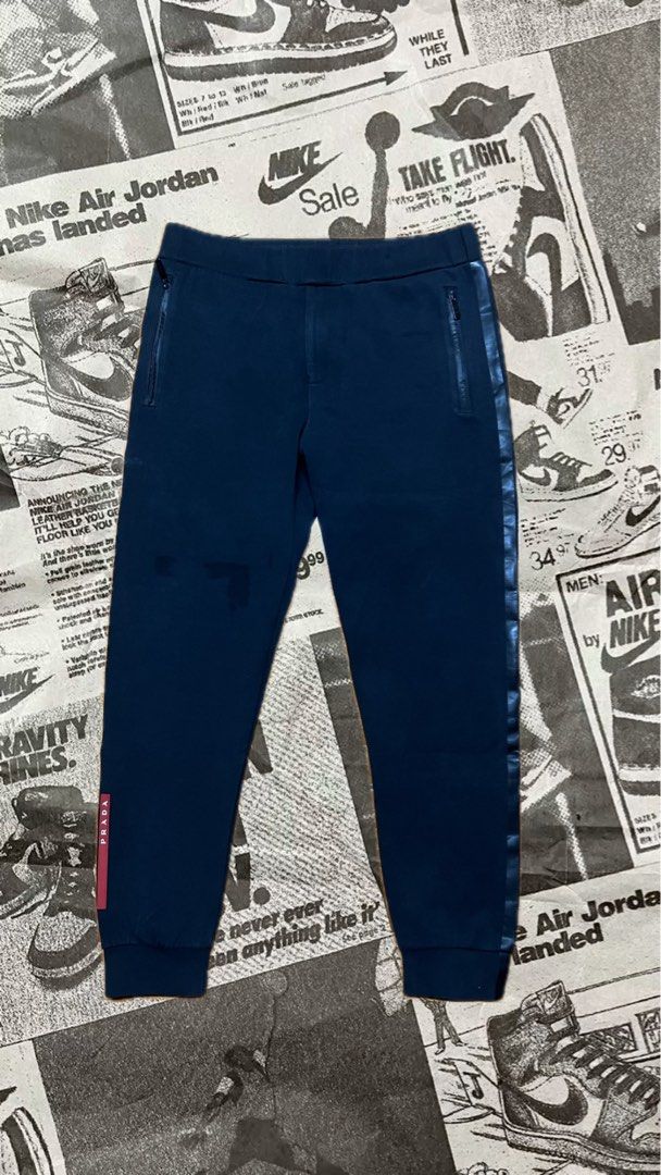 Prada Navy Blue Joggers Sweatpants Size XL (Category: Joggers) located in Manila. Submitted by jlfamiliar69452 (Listing ID 1471143818, Image 1). Description: - Brand: Prada - Item: Navy Blue Joggers - Size: XL (CN 190/104 A) - Origin: Made in Italy - Features: Side stripe details, secure zipped pockets, and signature red Prada logo tab on the lower leg - Details: Includes official Prada inner tag with name section - Condition: 100% authentic and 