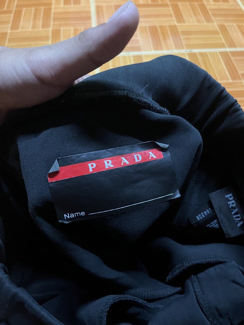 Prada Navy Blue Joggers Sweatpants Size XL (Category: Joggers) located in Manila. Submitted by jlfamiliar69452 (Listing ID 1471143818, Image 3). Description: - Brand: Prada - Item: Navy Blue Joggers - Size: XL (CN 190/104 A) - Origin: Made in Italy - Features: Side stripe details, secure zipped pockets, and signature red Prada logo tab on the lower leg - Details: Includes official Prada inner tag with name section - Condition: 100% authentic and 