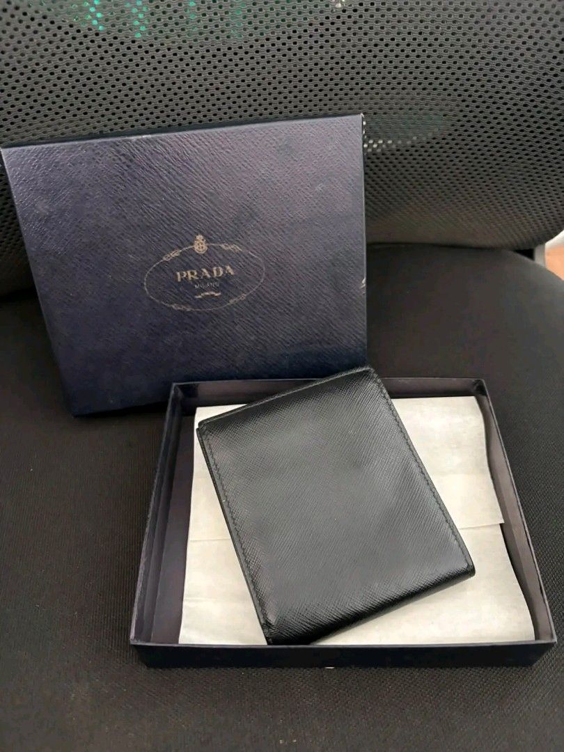 Prada Saffiano Leather Bifold Wallet (Category: Luxury Bags & Wallets) located in Zamboanga. Submitted by thriftbyeems (Listing ID 1471225587, Image 3). Description: FOR SALE! Prada Saffiano Leather Bifold Wallet (featuring the brand's signature metal lettering logo in the corner, resembling model 2MO513) RANK A AUTHENTIC 100% COMPLETE BOX AND CERTIFICATE DM TO PURCHASE 📲.