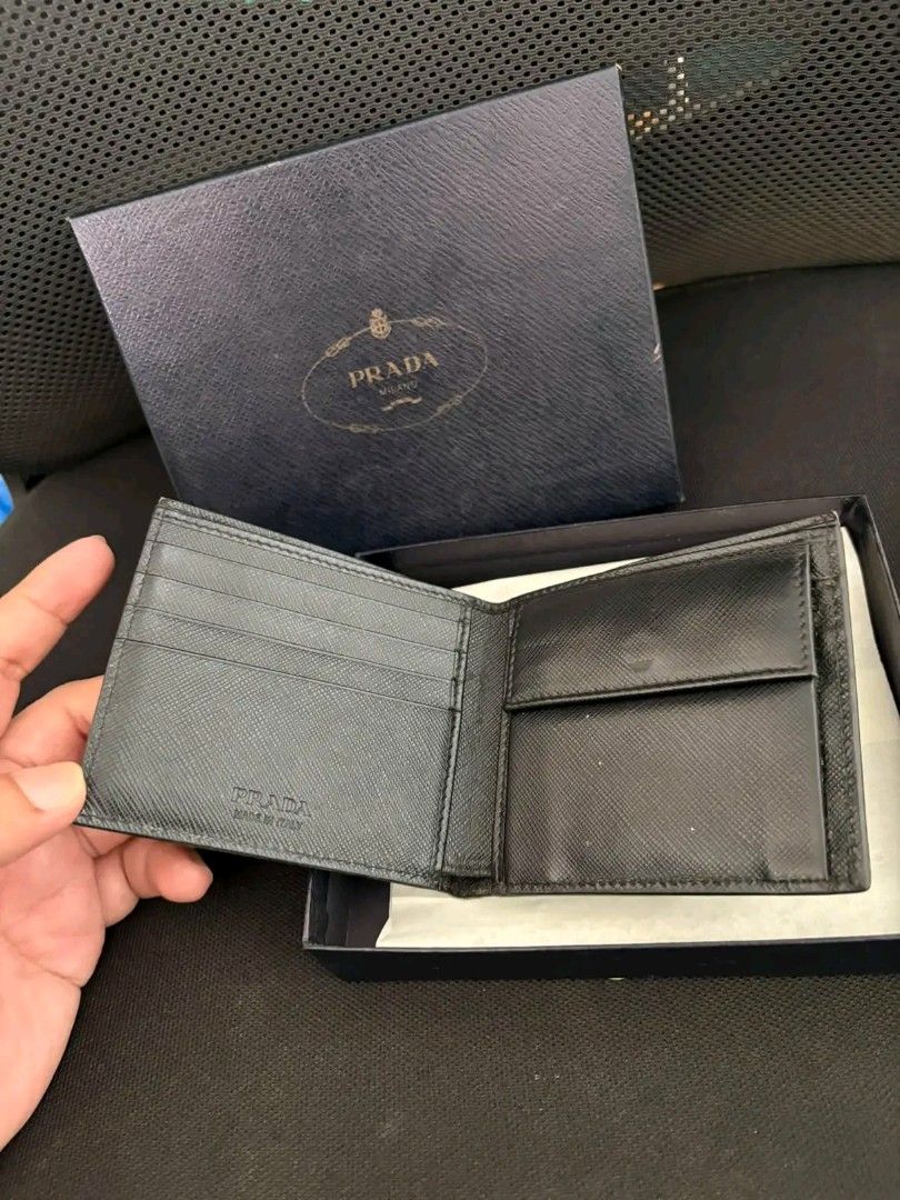 Prada Saffiano Leather Bifold Wallet (Category: Luxury Bags & Wallets) located in Zamboanga. Submitted by thriftbyeems (Listing ID 1471225587, Image 2). Description: FOR SALE! Prada Saffiano Leather Bifold Wallet (featuring the brand's signature metal lettering logo in the corner, resembling model 2MO513) RANK A AUTHENTIC 100% COMPLETE BOX AND CERTIFICATE DM TO PURCHASE 📲.