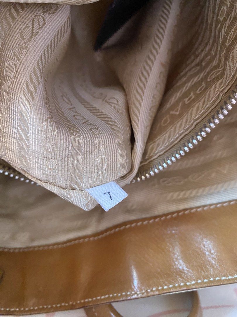 PRADA TESSUTO+VITELLO BUCKLE SHOULDER BAG (Category: Luxury Bags & Wallets) located in Binmaley. Submitted by vanilla_style (Listing ID 1471188270, Image 3). Description: Brand: Prada Color: Camel Model: Tessuto & Vitello Buckle Shoulder Bag Inclusion: CERTIFICATE OF AUTHENTICITY Condition: Good condition may mga marks lang po siya, check niyo nalang po posted naman na po lahat.☺️ DM FOR MORE PICTURES☺️.