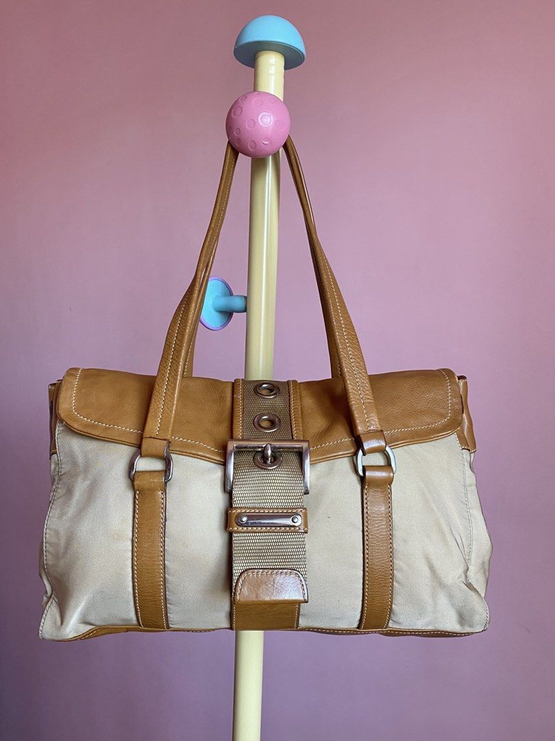PRADA TESSUTO+VITELLO BUCKLE SHOULDER BAG (Category: Luxury Bags & Wallets) located in Binmaley. Submitted by vanilla_style (Listing ID 1471188270, Image 1). Description: Brand: Prada Color: Camel Model: Tessuto & Vitello Buckle Shoulder Bag Inclusion: CERTIFICATE OF AUTHENTICITY Condition: Good condition may mga marks lang po siya, check niyo nalang po posted naman na po lahat.☺️ DM FOR MORE PICTURES☺️.
