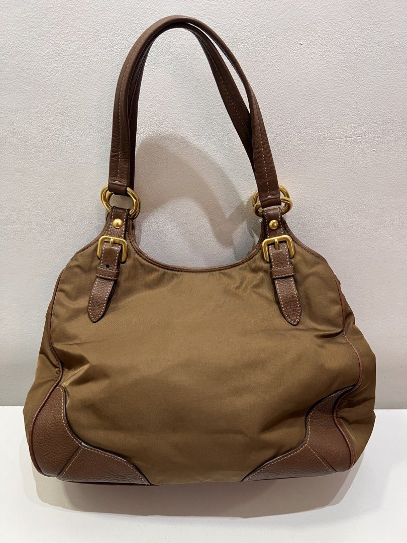Pre-loved Prada Hobo Nylon Tote Bag (Category: Luxury Bags & Wallets) located in Cebu City. Submitted by brandedcorner_ph (Listing ID 1471181921, Image 2). Description: Pre-loved ((P))rada Hobo Nylon Tote Bag 100% Authentic or money back Condition • Excellent condition • No flaws Product Details •Color: Golden brown •Hardware: Gold tone •Material: Nylon & leather •Approximate Dimensions in inches: H10 x W12 x D5.8 Color may vary due to lighting. 