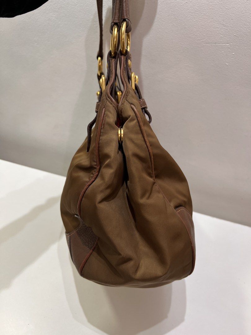 Pre-loved Prada Hobo Nylon Tote Bag (Category: Luxury Bags & Wallets) located in Cebu City. Submitted by brandedcorner_ph (Listing ID 1471181921, Image 3). Description: Pre-loved ((P))rada Hobo Nylon Tote Bag 100% Authentic or money back Condition • Excellent condition • No flaws Product Details •Color: Golden brown •Hardware: Gold tone •Material: Nylon & leather •Approximate Dimensions in inches: H10 x W12 x D5.8 Color may vary due to lighting. 