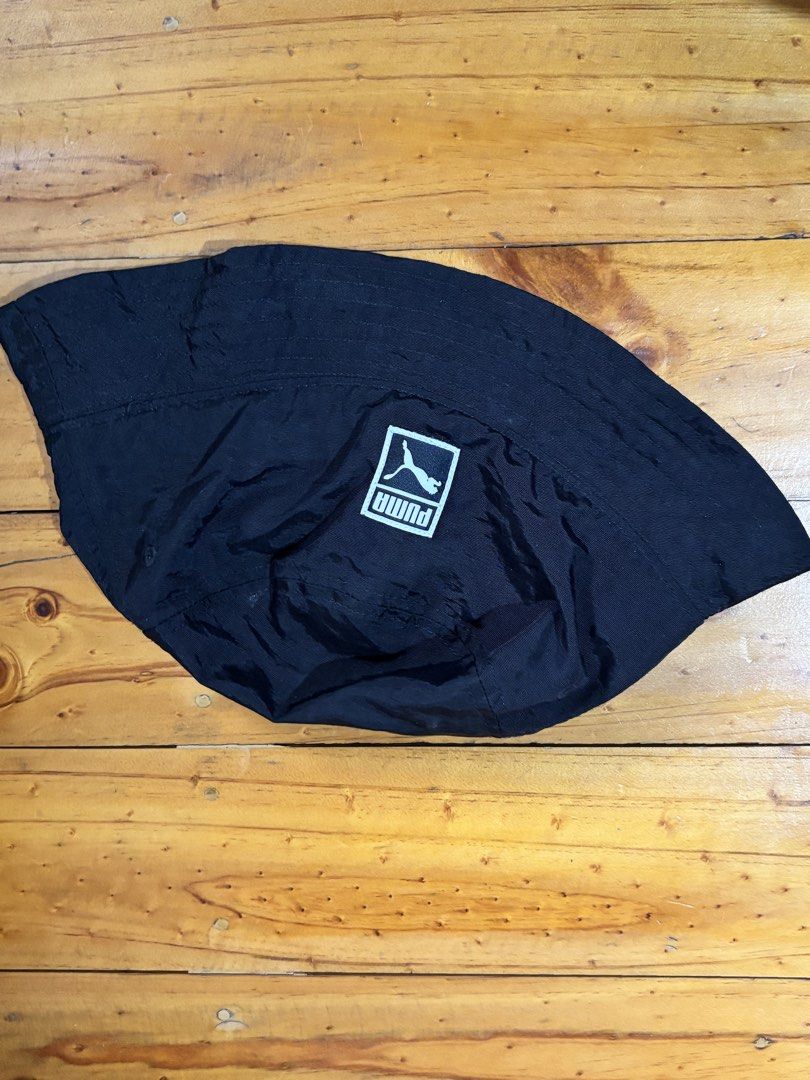 Puma Black Bucket Hat S/M 021337 04 (Category: Hats & Beanies) located in Manila. Submitted by kszortpdrss (Listing ID 1471159614, Image 1). Description: - Brand: Puma - Color: Classic Black - Size: S/M (57 cm circumference) - Design: Timeless bucket hat with sewn-on front logo patch - Details: Includes inner style tag (021337 04) and barcode - Condition: Brand new / Excellent - Perfect for daily casual streetwear and sun protection.