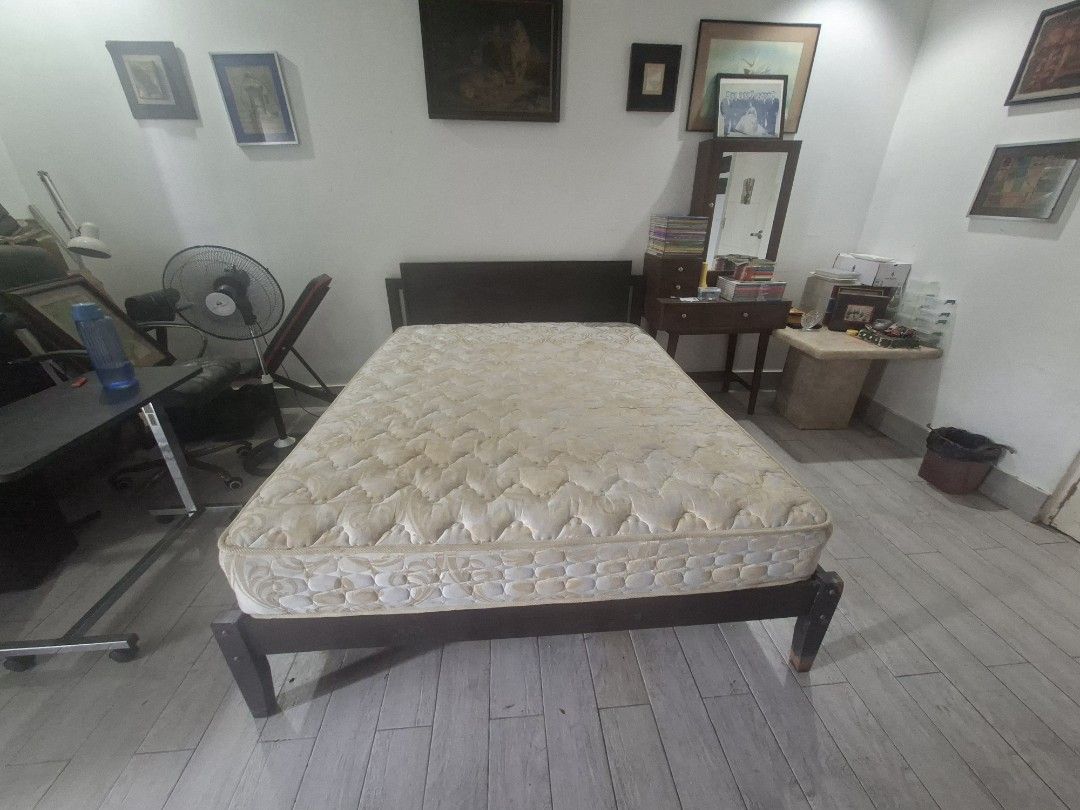 Queen Sized Dark brown wooden bed frame with cream pattern spring mattress (Category: Bed Frames & Mattresses) located in Las Pinas. Submitted by feliboykins (Listing ID 1471216844, Image 3). Description: - Sturdy dark wood bed frame with a matching headboard - Includes a thick, comfortable spring mattress with cream and beige pattern - Standard double or queen size - Solid wooden legs for strong and reliable support - Ideal for master bedrooms o
