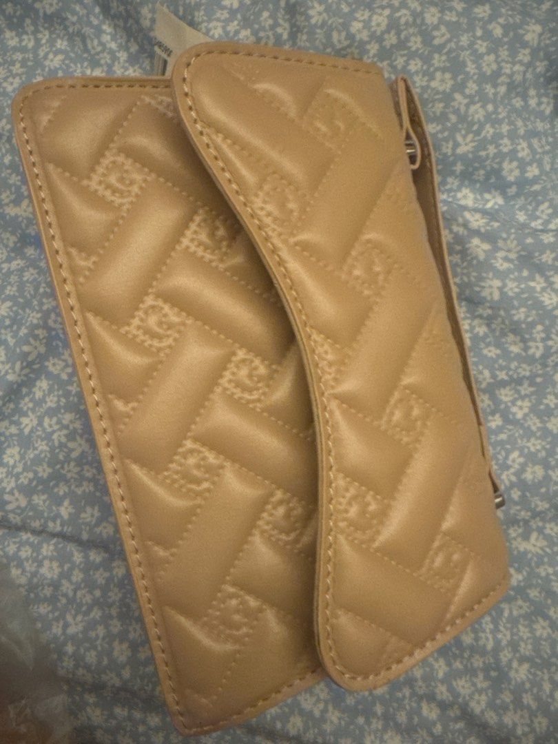 Quilted Beige Crossbody Bag with Monogram Pattern and Wristlet (Category: Cross-body Bags) located in Quezon City. Submitted by puredragon_9f8b39 (Listing ID 1471276523, Image 1). Description: - Color: Versatile neutral beige - Design: All-over quilted monogram texture with a clean, structured shape - Closure: Secure flap with snap button - Interior: Includes lining and a folded strap - Condition: Brand new with tag still attached - Style: Perfec