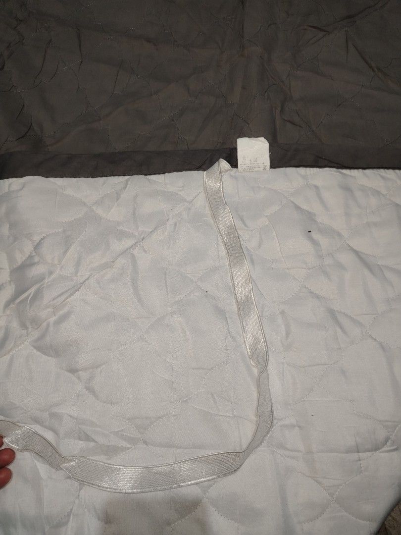 Quilted Grey Mattress Topper with Corner Elastic Straps (Category: Bed Frames & Mattresses) located in Manila. Submitted by mimachelleukay (Listing ID 1471257926, Image 2). Description: - Color: Stylish grey with patterned stitching - Material: Soft and comfortable fabric with white backing - Secure Fit: Fitted with elastic bands on all four corners - Easy Maintenance: Simple to put on, take off, and machine wash - Size: Standard rectangular shap