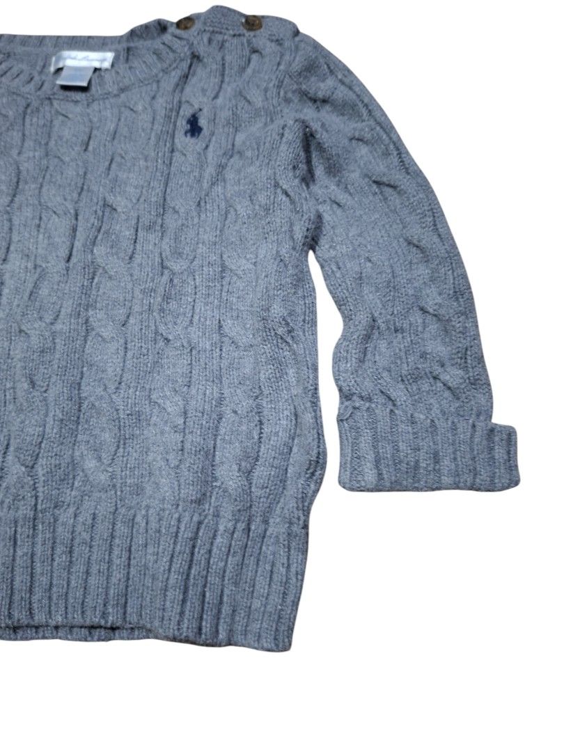 Ralph Lauren Cable Knit Grey Sweater 18M (Category: Babies & Kids Fashion) located in San Juan (Cabalian). Submitted by ec8thrift (Listing ID 1471253175, Image 3). Description: - Brand: Ralph Lauren - Size: 18 months - Color: Grey with navy blue embroidered polo logo - Material: Soft, warm knit - Design: Classic cable knit, crewneck - Feature: Shoulder button closure for easy changing - Finish: Ribbed hem and cuffs.