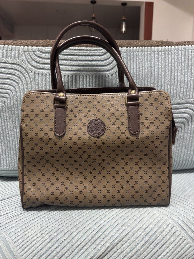 Rebika Monogram Tote Bag Brown Handbag (Category: Tote Bags) located in Imus. Submitted by budolfindsimus (Listing ID 1471256830, Image 1). Description: 🤎 AB Monogram Tote - Old Money Vibes! Pang office / pang mayaman aesthetic ✨ AB monogram pattern + brown leather handles + gold hardware Details: 📏 Medium-kasya tablet / documents 🤎 3 compartments - organized! ✨ May zipper sa likod + magnetic closure sa loob 👛 Clean inside - black lining 💼 S