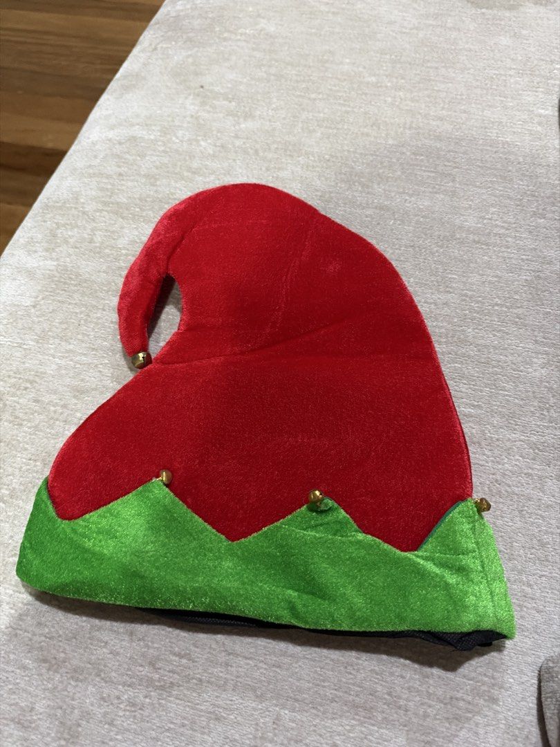Red and Green Elf Hat with Bells (Category: Caps & Hats) located in Manila. Submitted by jamilleice33407 (Listing ID 1471244592, Image 1). Description: - Festive red and green velvet elf hat - Pointed design with a trendy folded top - Decorated with four small gold jingle bells on the tips - Perfect for Christmas parties, events, and holiday dress-up - Brand new and ready to ship!.