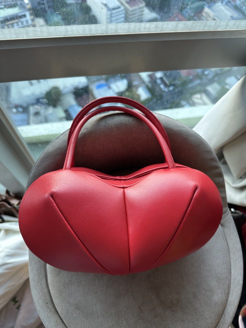 Red Heart Shaped Leather Handbag (Category: Purses & Pouches) located in Imus. Submitted by ann__xoxo (Listing ID 1471165541, Image 1). Description: - Red heart-shaped structured bag - Unique puffed panels with clean stitching - Vibrant red exterior and solid red interior lining - Convenient top handles - Perfect statement piece for dates and nights out - Grab it before it goes!.