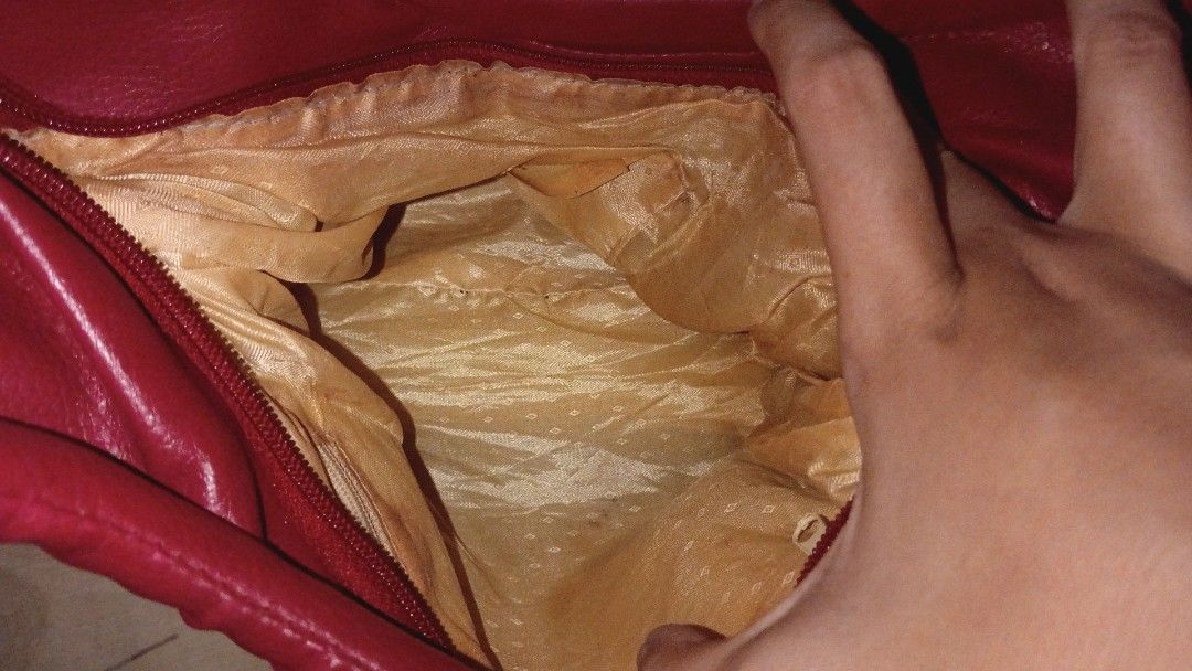 Red Leather Shoulder Bag with Gold Hardware (Category: Luxury Bags & Wallets) located in Iligan City. Submitted by freiko (Listing ID 1471275538, Image 3). Description: - Color: Bright red - Material: Soft faux leather with gold-tone hardware - Straps: Double top handles - Details: Chic side drawstring accents - Interior: Spacious beige patterned fabric lining - Closure: Secure top zipper closure - Condition: Brand new/Excellent.