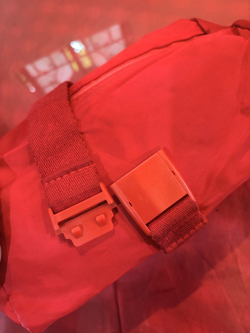 Red Nylon Crossbody Bag with Buckle Strap (Category: Cross-body Bags) located in Manila. Submitted by harpymonetttt (Listing ID 1471149874, Image 3). Description: - Bright red color - Nylon material - Has back zippered pocket for small essentials - Has one pocket inside - Thick and adjustable strap - Fits phone and some anik anik - Dainty-sized bag perfect for a pop of color in your OOTDs.