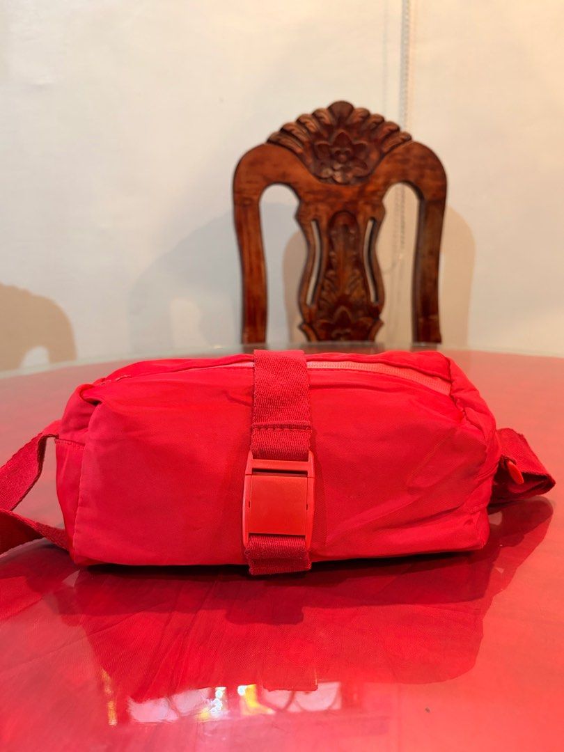 Red Nylon Crossbody Bag with Buckle Strap (Category: Cross-body Bags) located in Manila. Submitted by harpymonetttt (Listing ID 1471149874, Image 1). Description: - Bright red color - Nylon material - Has back zippered pocket for small essentials - Has one pocket inside - Thick and adjustable strap - Fits phone and some anik anik - Dainty-sized bag perfect for a pop of color in your OOTDs.