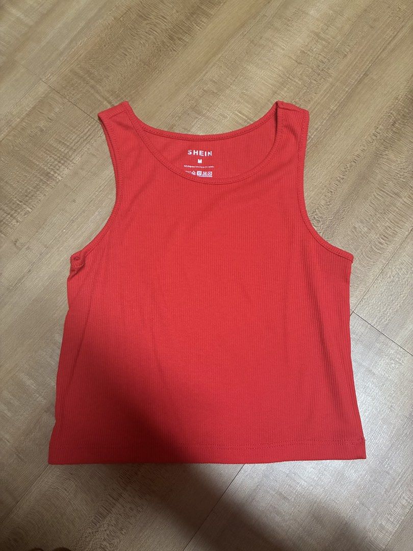 Red Ribbed Tank cropped Top Size M (Category: Sleeveless) located in Quezon City. Submitted by habits.mnl (Listing ID 1471160911, Image 1). Description: - Brand: Shein - Size: Medium - Color: Bright red - Material: Soft, stretchy ribbed fabric - Design: Scoop neckline, sleeveless, straight hem, tagless inner collar - Condition: Excellent basic piece for layering or warm weather wear.