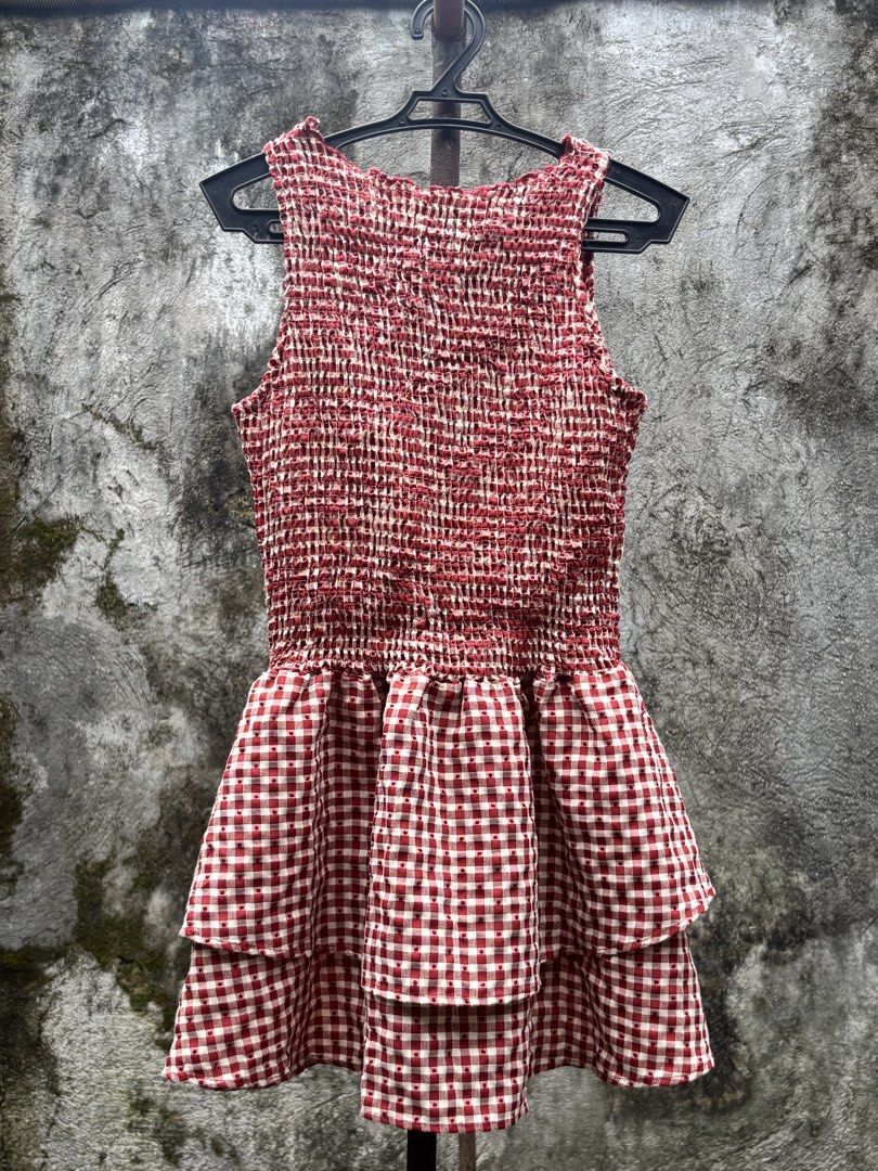 Red White Gingham Checkered Smocked Ruffle Mini Dress (Category: Dresses) located in Manila. Submitted by kszortpdrss (Listing ID 1471156684, Image 1). Description: - Classic red and white gingham checkered pattern - Comfortable smocked bodice with great stretch - Trendy layered ruffle skirt style - Sleeveless design, ideal for warm weather - Lightweight fabric with cute textured dots throughout - Perfect, stylish look for picnics and casual outi