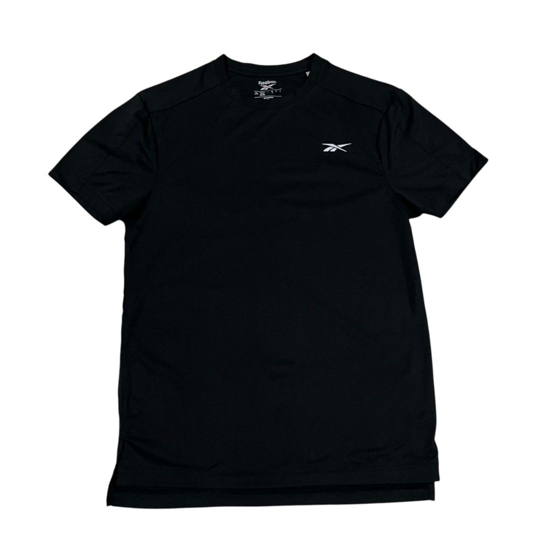 Reebok Black Athletic T-Shirt (Category: Activewear) located in Cagayan de Oro. Submitted by lootfindzzzz (Listing ID 1471233472, Image 1). Description: - Brand: Reebok - Color: Solid black - Style: Crew neck, short sleeves - Design: Small Reebok delta logo on left chest - Fit/Details: Lightweight fabric, drop tail hem with side slits - Ideal for: Gym workouts, sports, or daily casual wear.