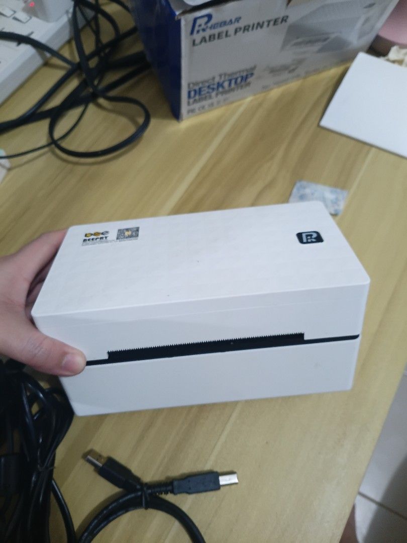 Thermal Label Printer with Thermal Paper (Category: Printers, Scanners & Copiers) located in Pasig City. Submitted by mryln (Listing ID 1471237681, Image 2). Description: - RHEBAR brand - desktop and mobile compatible - Perfect for waybill/ shipping label printing - With power adapter and USB cable - With black label roll holder stand - Includes 4 packs of sealed thermal paper stacks - Original box included pickup loc: Pasig delivery only via cou
