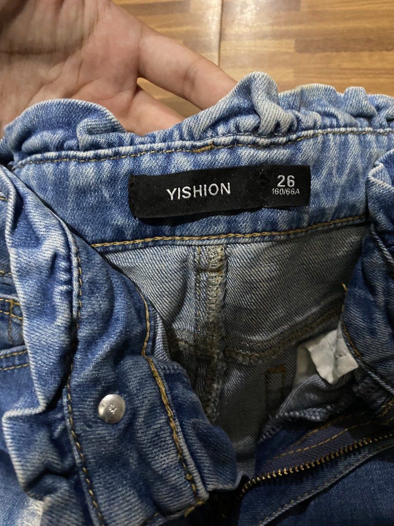 Ripped Jeans (Category: Jeans) located in Manila. Submitted by ellieeeeee0293929 (Listing ID 1471121591, Image 2). Description: - Brand: Yishion - Size: 26 - Style: High-waist paperbag ruffle waistband - Wash: Light wash classic denim - Details: Ripped knees with frayed distressing and folded cuffs - Closure: Front zipper and button closure.
