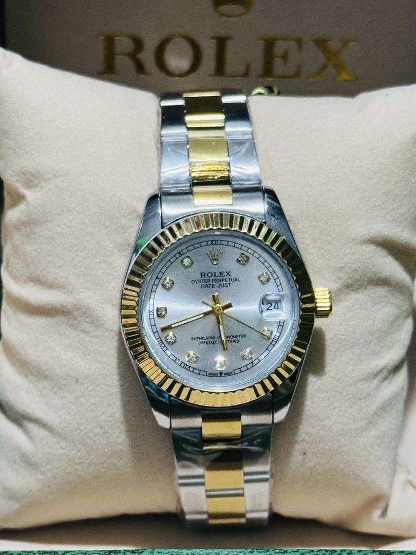Rolex Oyster Perpetual Date Just Watch (Category: Luxury Watches) located in Manila. Submitted by mbcollections251 (Listing ID 1471237129, Image 1). Description: - Model: Rolex Datejust - Design: Two-tone silver and gold (steel and gold bracelet) - Bezel: Iconic fluted bezel - Dial: Silver sunburst dial with sparkling diamond hour markers - Features: Date window at 3 o'clock with cyclops lens - Inclusions: Comes with branded Rolex presentation bo