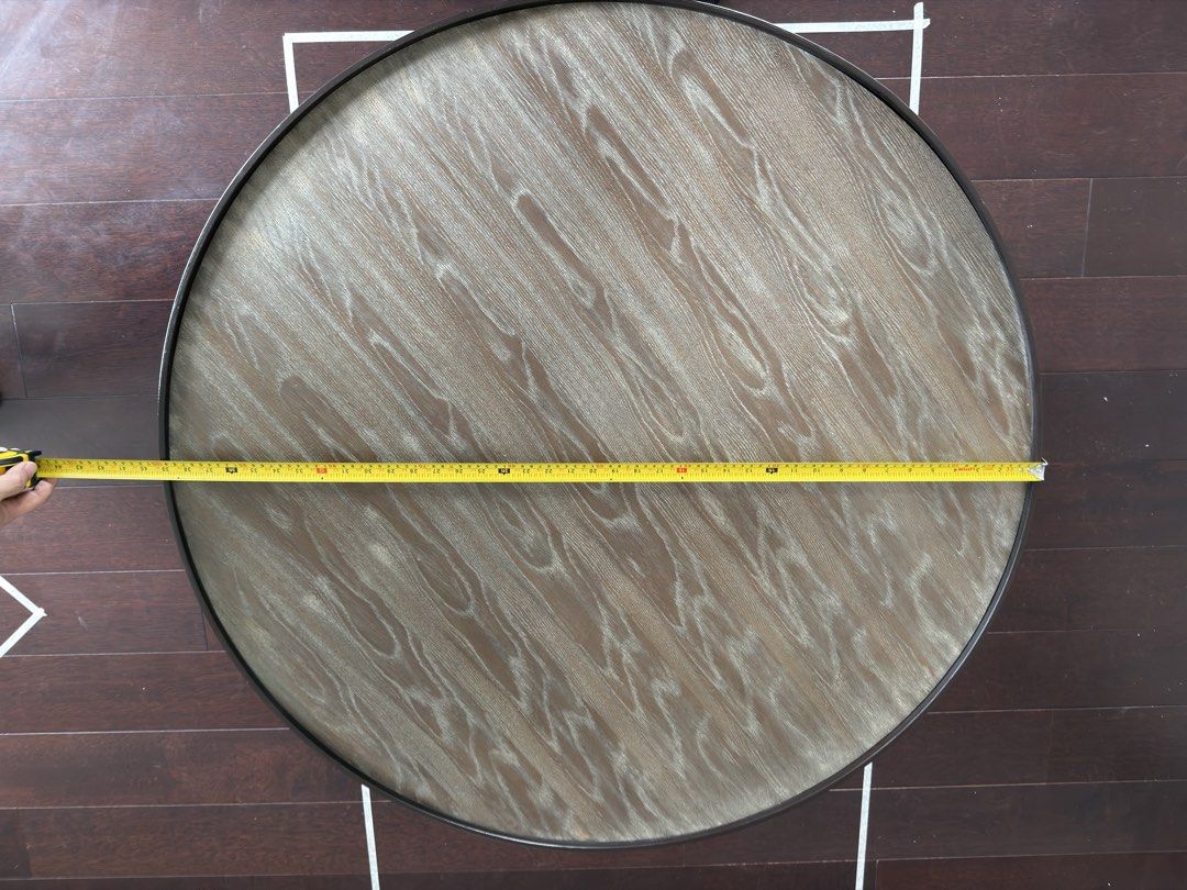 Round Wooden Coffee Table with Steel Base (Category: Tables & Sets) located in Taguig. Submitted by bankysa21 (Listing ID 1471152342, Image 2). Description: Modern Round Wooden Coffee Table with Black Steel Base | 100cm in diameter, 42cm height Selling a modern round wooden coffee table with a sleek black steel base. Features a wood-grain tabletop and sturdy metal frame, making it a stylish yet functional addition to any living room. Dimensions: 