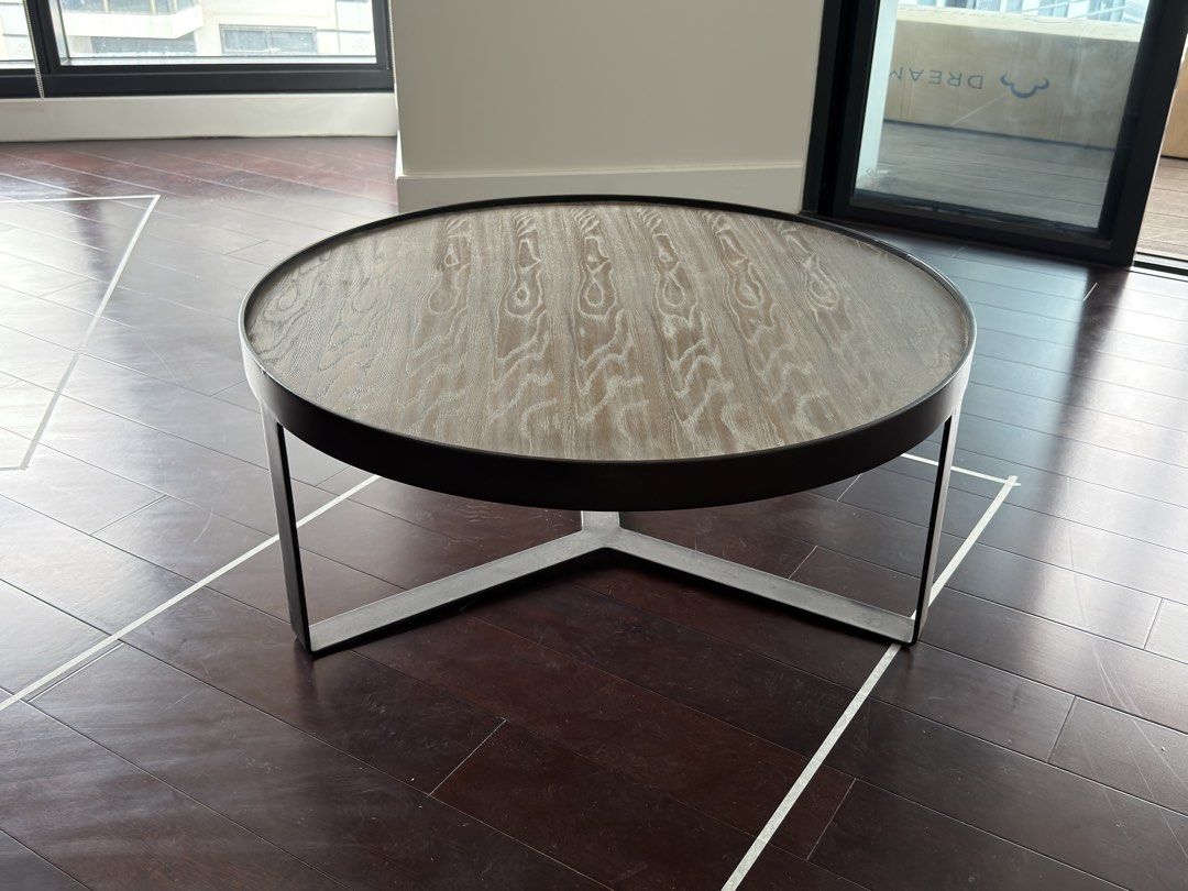 Round Wooden Coffee Table with Steel Base (Category: Tables & Sets) located in Taguig. Submitted by bankysa21 (Listing ID 1471152342, Image 1). Description: Modern Round Wooden Coffee Table with Black Steel Base | 100cm in diameter, 42cm height Selling a modern round wooden coffee table with a sleek black steel base. Features a wood-grain tabletop and sturdy metal frame, making it a stylish yet functional addition to any living room. Dimensions: 