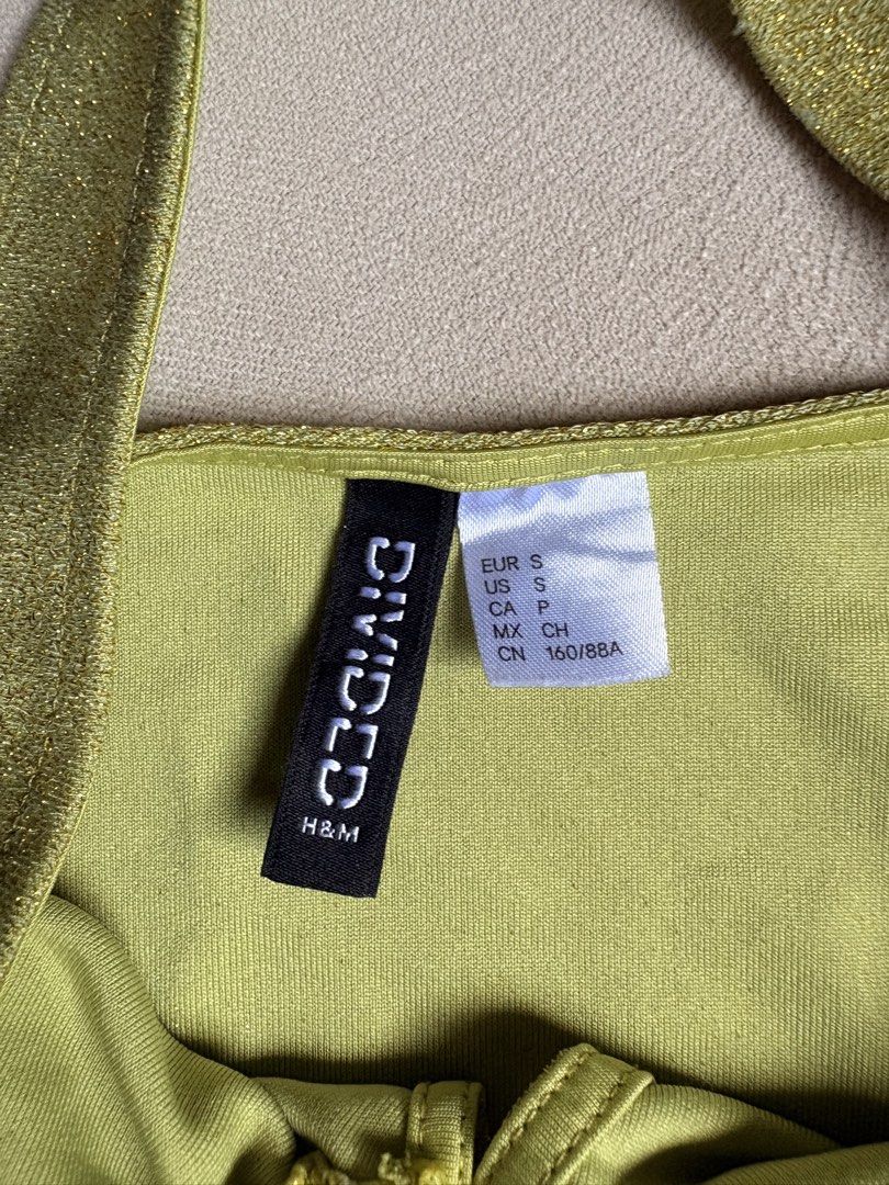 RUSH!!! H&M Divided Lime Green Glittery Halter Top (Category: Sleeveless) located in Makati City. Submitted by savannahsison (Listing ID 1471130988, Image 2). Description: - No flaws! used less than 10x probably - super cute!!! -Brand: H&M Divided - Color: Lime green with sparkly metallic finish - Size: S - Details: Center ring detail, front slit, halter neck tie-back.