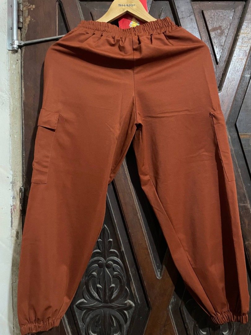 Rust Orange Cargo Pants with Drawstring Waist (Category: Joggers) located in Manila. Submitted by happylion-55c640 (Listing ID 1471285989, Image 2). Description: Size: M-L adjustable Color: Rust orange Style: Tapered fit with elasticated ankle cuffs w/ 2 pockets on both sides Material: Lightweight and breathable fabric.