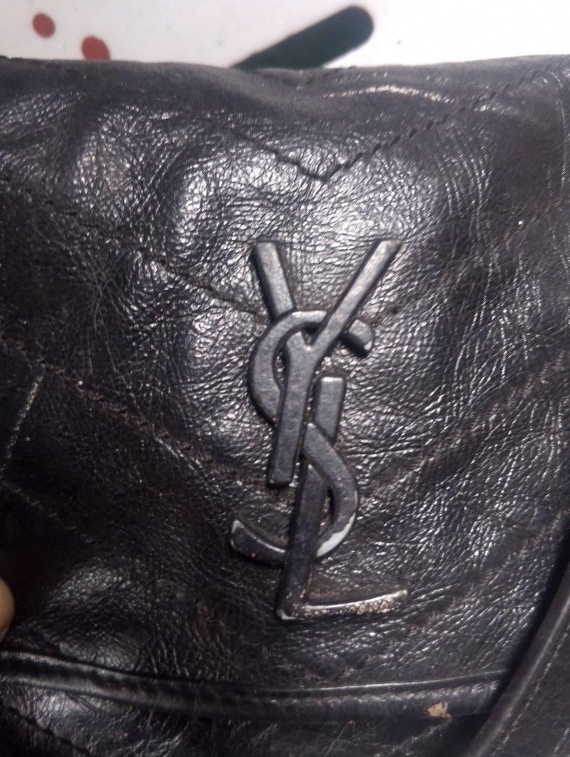 Saint Laurent Black Leather Monogram Shoulder Bag (Category: Luxury Bags & Wallets) located in Caloocan City. Submitted by ndkph (Listing ID 1471165381, Image 3). Description: Black quilted leather Saint Laurent handbag with black hardware and the YSL logo on the front. Chain strap with a leather shoulder guard. Saint Laurent Paris embossed inside and around the metal eyelets on the sides. Visible wear and scuffs on the leather body and hardware.