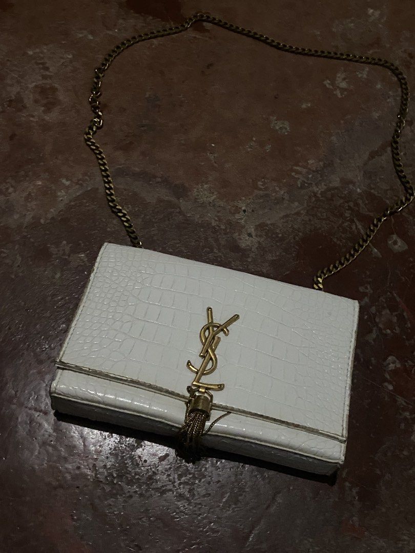 Saint Laurent White Croc Embossed Chain Wallet Bag (Category: Luxury Bags & Wallets) located in Davao. Submitted by singkorayk15407 (Listing ID 1471237111, Image 1). Description: - Authentic Saint Laurent crossbody bag - Premium white croc-embossed leather with gold hardware - Iconic YSL logo and stylish tassel detail - Convenient chain strap for easy wear - Secure magnetic snap closure - Interior features YSL Paris heat stamp and built-in card s
